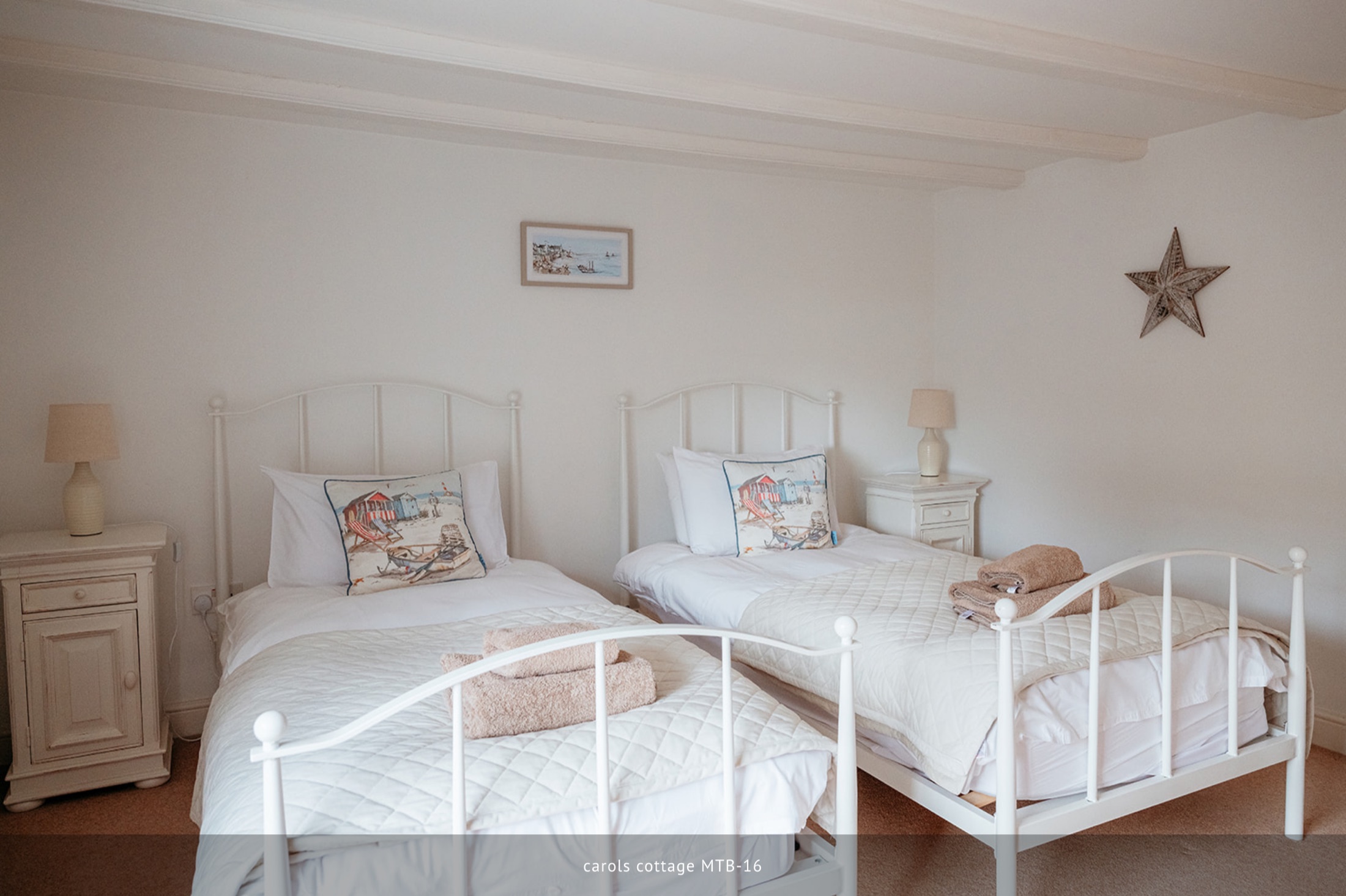 Twin bedroom with two white beds